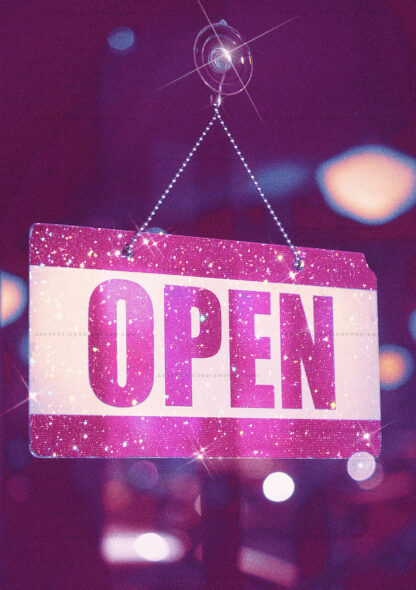 Aesthetic image of pink bling aesthetic open sign hanging on a glass door